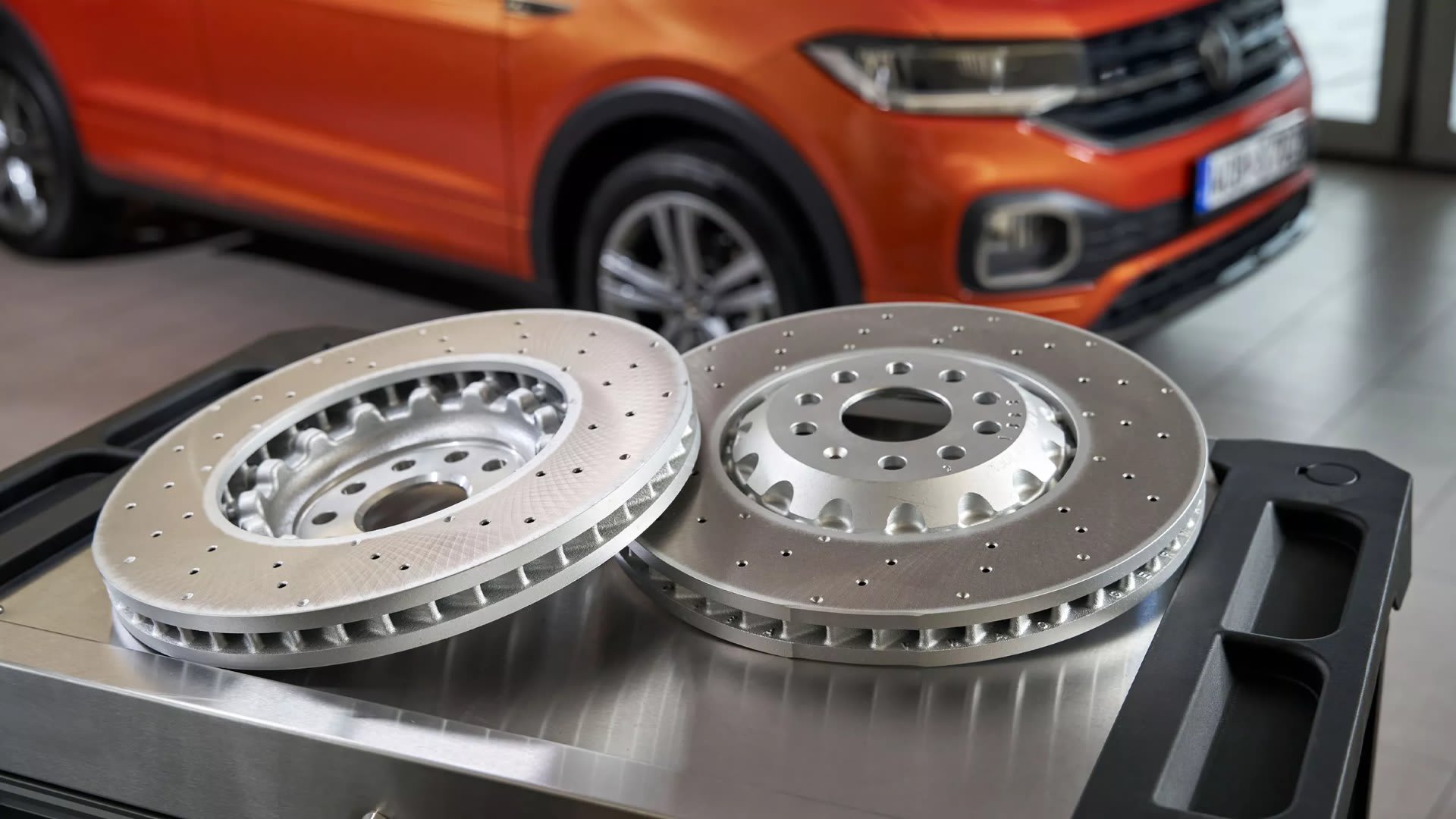 Two Volkswagen Genuine brake discs on a workshop bench – repairs and genuine parts at Camerons Volkswagen, Perth