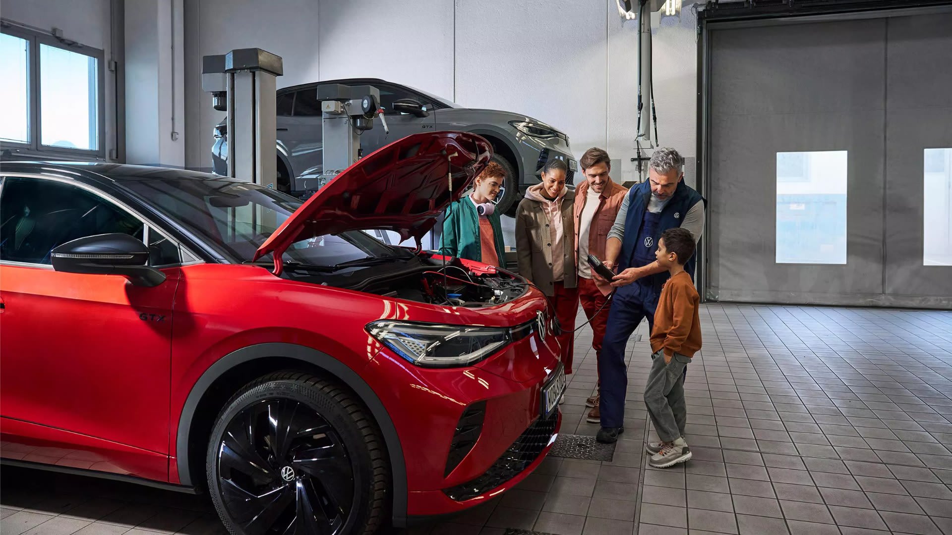 Family with a Volkswagen technician during a battery check on an ID.5 – batteries at Camerons Volkswagen, Perth