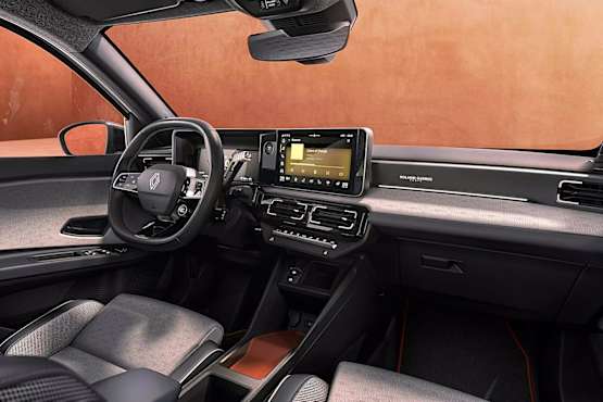 Renault 5 Roland Garros interior featuring a steering wheel, touchscreen display, and stylish upholstery.