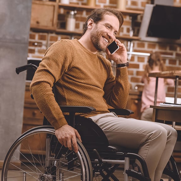 Handicapped gentleman smiling whilst on the phone