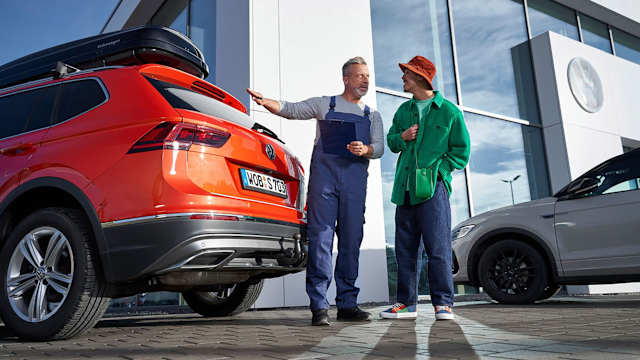 Volkswagen technician handing back a Tiguan to its owner after a service – Camerons Volkswagen, Perth