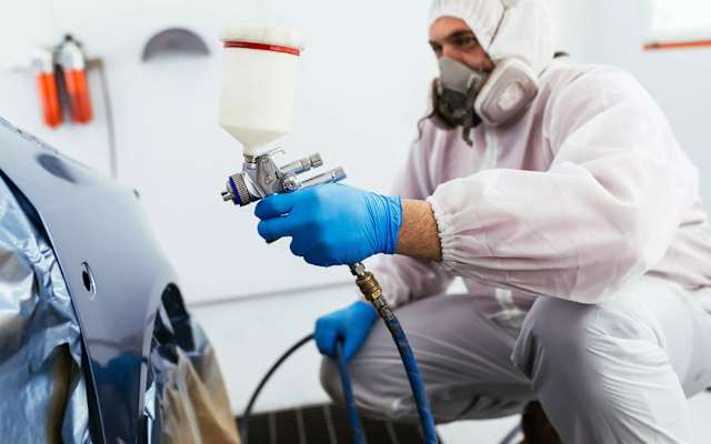 Volkswagen approved bodyshop technician spray painting a panel – Cameron Group Bodyshop, Perth