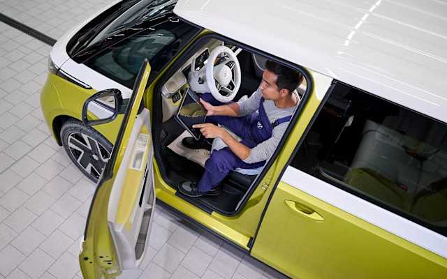 Volkswagen technician connecting a laptop to an ID.3 – electric vehicle diagnostics at Camerons Volkswagen, Perth