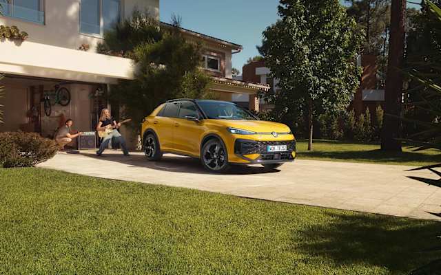 New Volkswagen T-Roc parked in front of a garage – T-Roc finance offers at Camerons Volkswagen, Perth