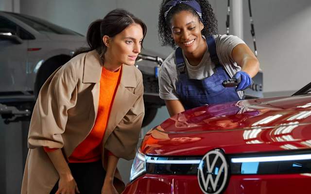 Volkswagen expert and customer inspecting paintwork – body and paint repairs at Camerons Volkswagen, Perth