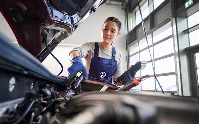 Volkswagen technician testing a car battery – battery testing at Camerons Volkswagen, Perth