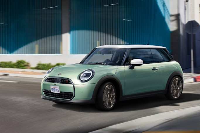 MINI cooper driving on a road