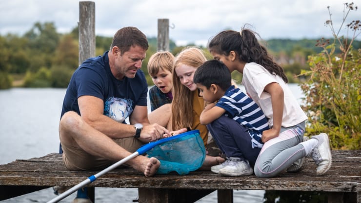 Steve Backshall introduces a group of children to pond dipping.
