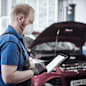 A Ford technician updating digital service records