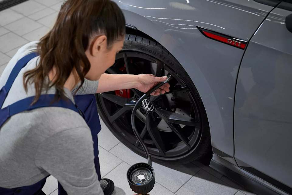 Volkswagen technician checking tyre pressure – Camerons Volkswagen, Perth