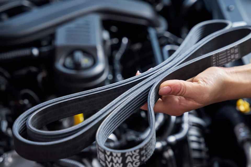 Volkswagen Genuine timing belt in front of an engine bay – cambelt replacement at Camerons Volkswagen, Perth