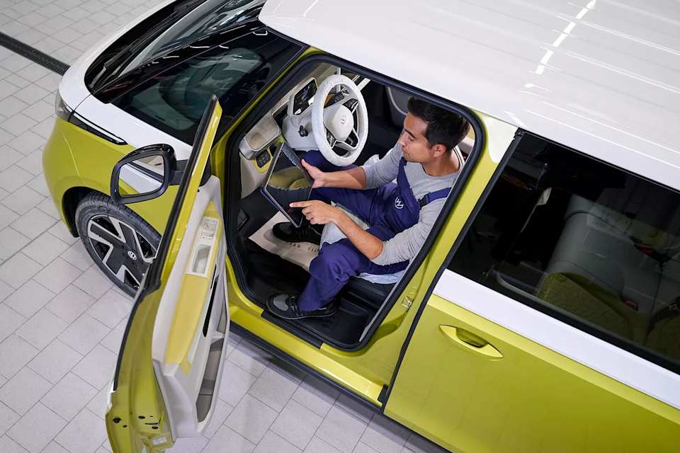 Volkswagen technician connecting a laptop to an ID.3 – electric vehicle diagnostics at Camerons Volkswagen, Perth