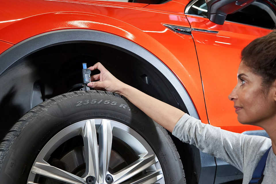 Volkswagen technician measuring tyre tread depth – tyre checks at Camerons Volkswagen, Perth