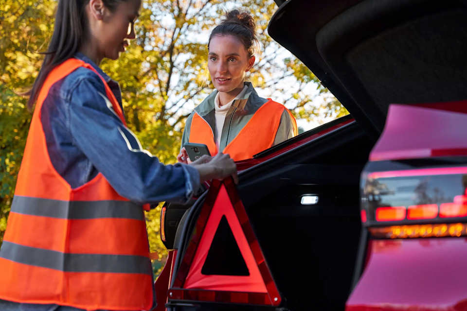Two drivers in high-vis vests beside a Volkswagen ID.5 after a breakdown – accident assistance from Camerons Volkswagen, Perth