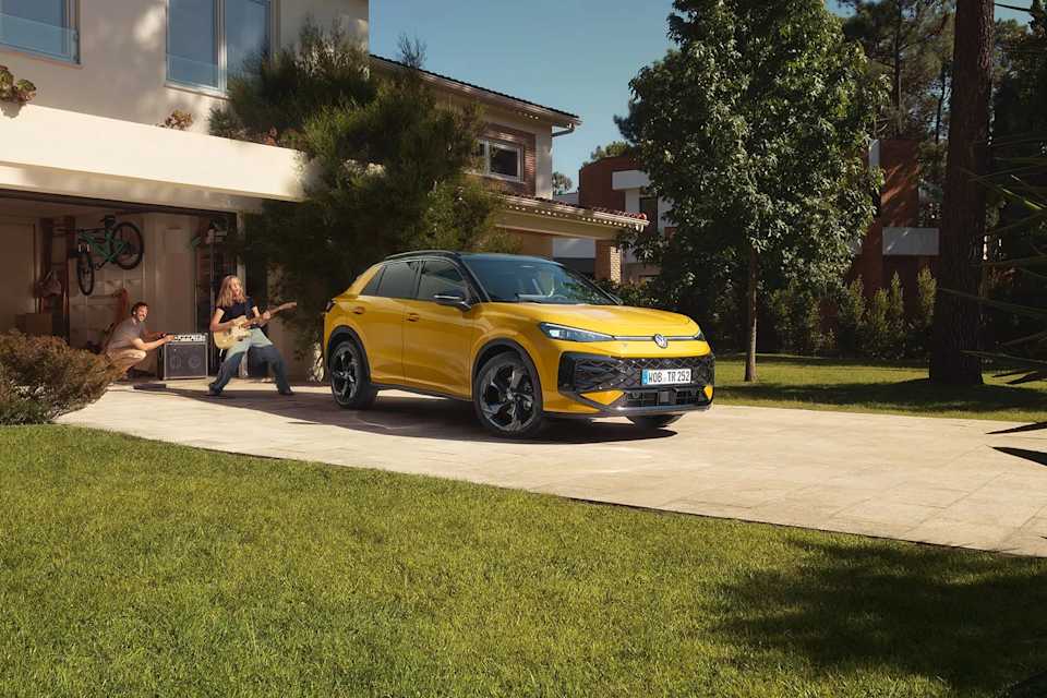 New Volkswagen T-Roc parked in front of a garage – T-Roc finance offers at Camerons Volkswagen, Perth