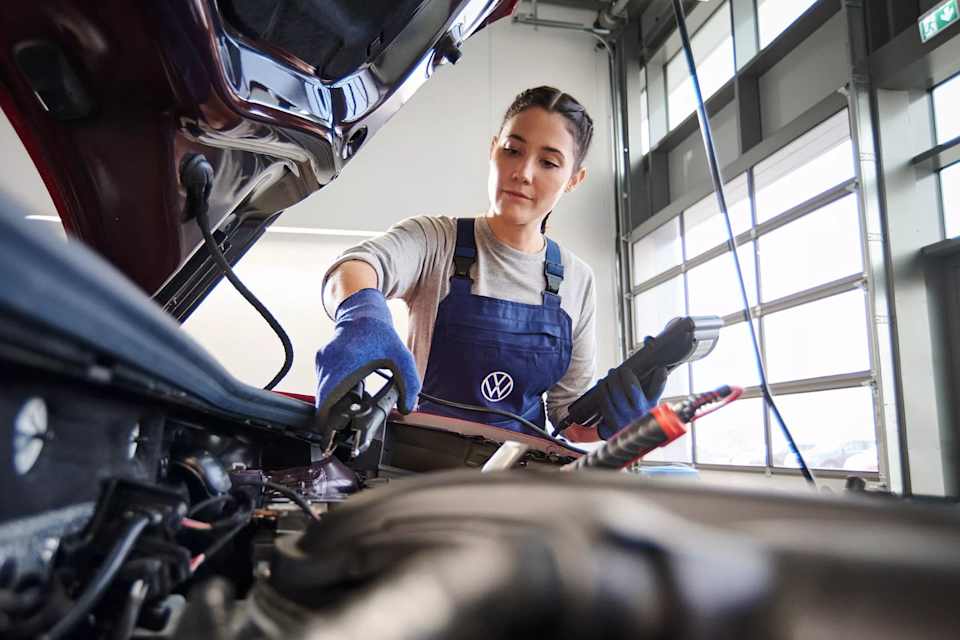 Volkswagen technician testing a car battery – battery testing at Camerons Volkswagen, Perth