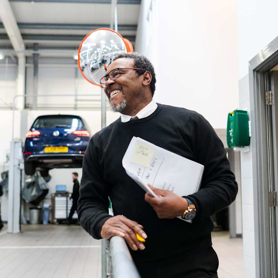 Volkswagen service adviser with paperwork – buy a service plan at Camerons Volkswagen, Perth